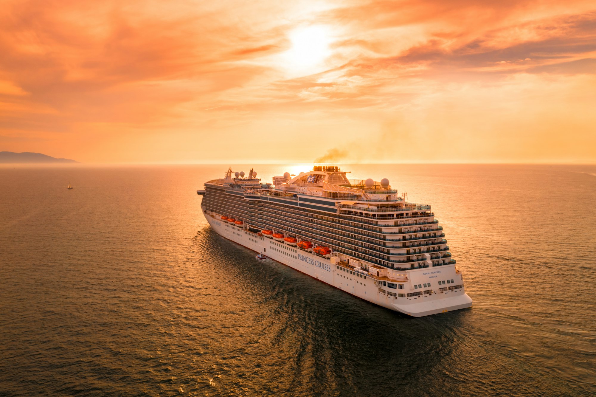 A cruise ship at sea at sunset